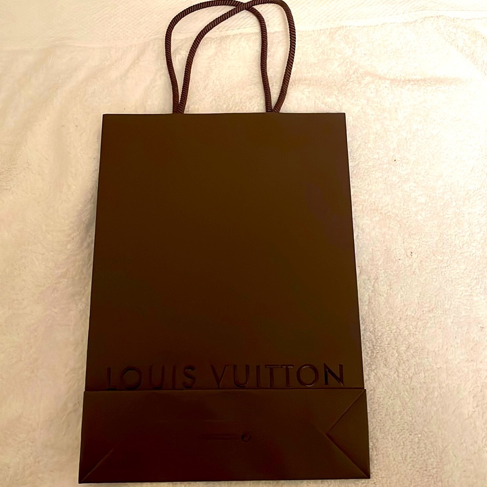 Louis Vuitton authentic gift bag measures approx. 8x 11 inches. Never opened.